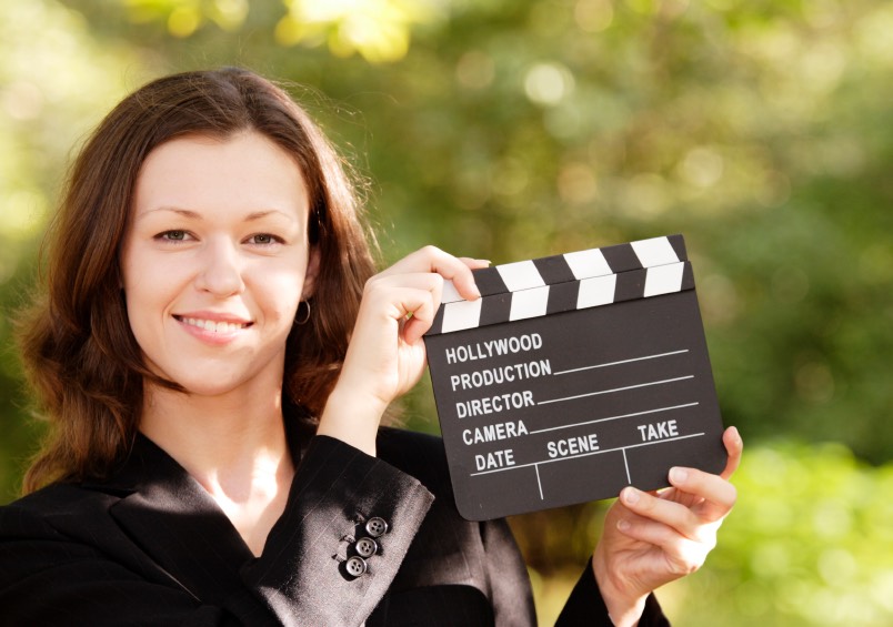 Woman with Smile and Closed Clapboard
